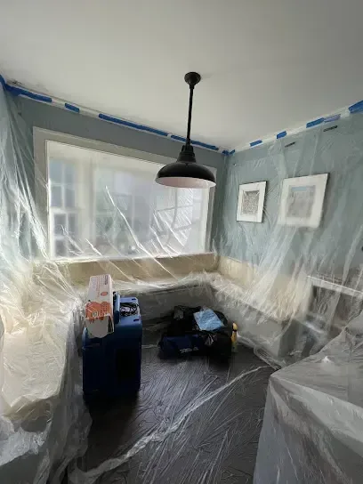 Room wrapped in plastic containment sheeting during a water damage dry-out