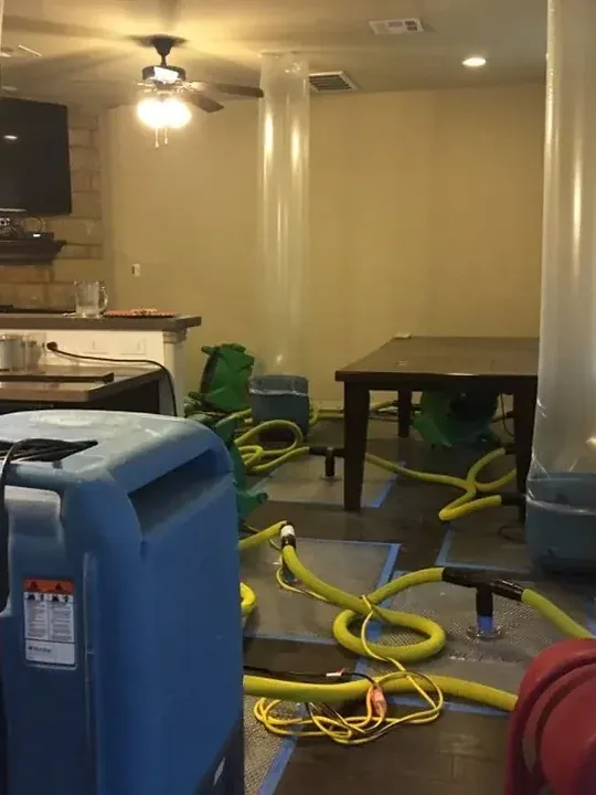 Truck-mounted water extraction gear and hoses set up on a job site