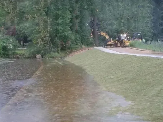 Storm water covering a lawn and low ground after heavy rain