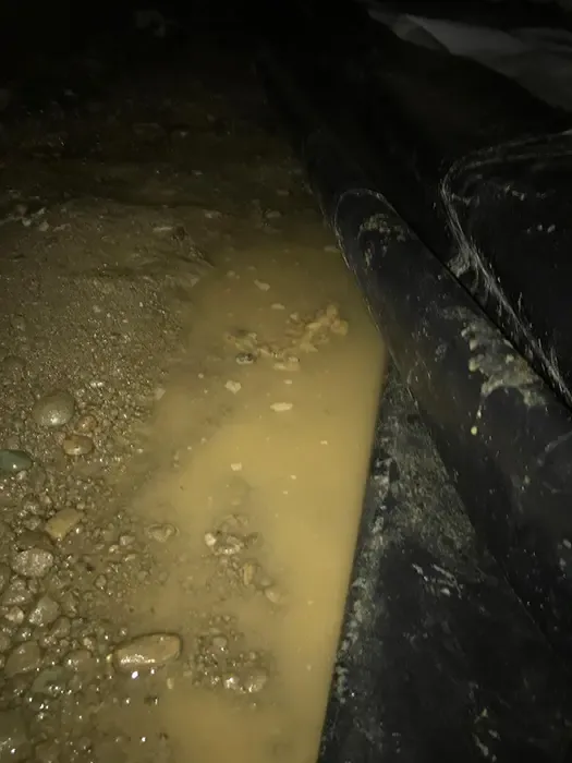 Standing water pooled in the crawl space under a home